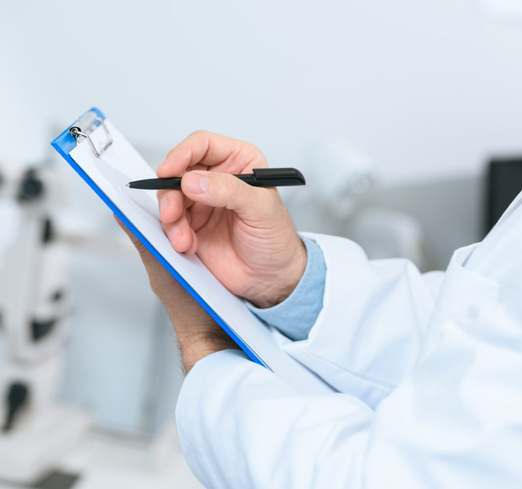 cropped-view-of-optician-writing-diagnosis-in-clinic.jpg
