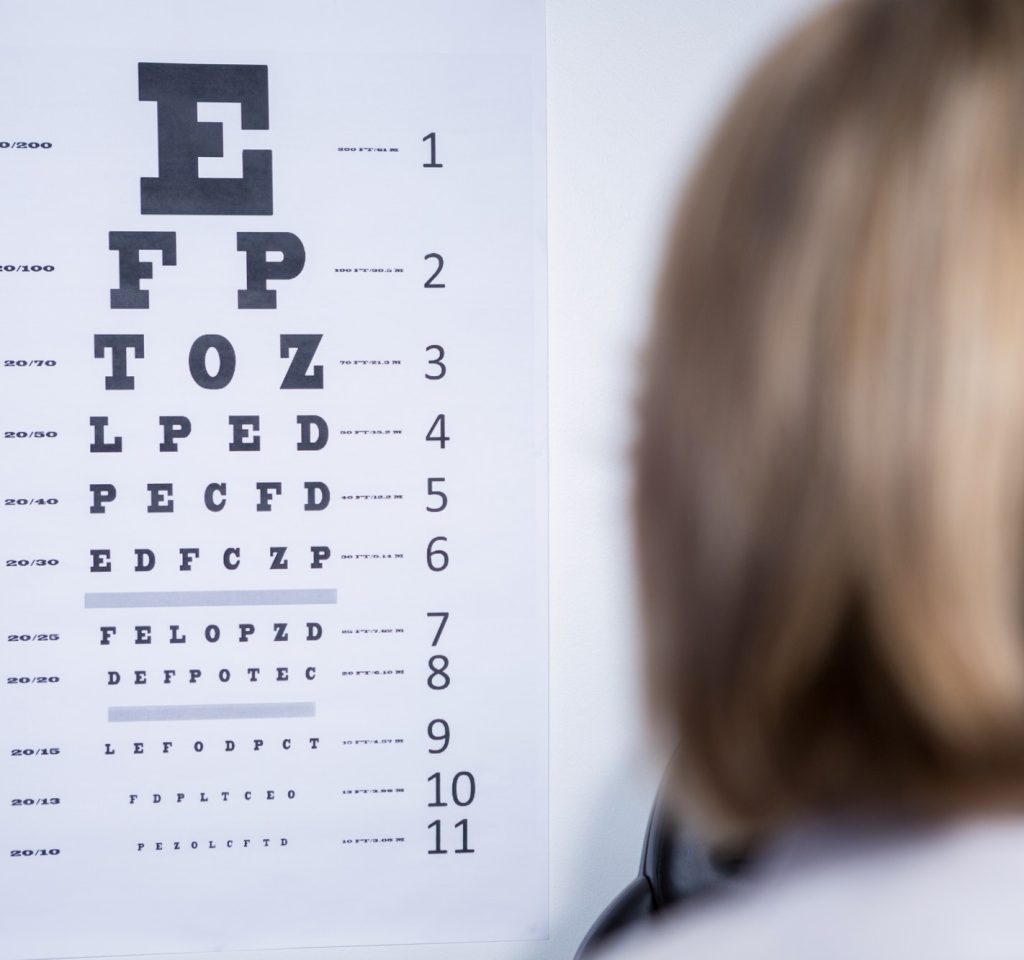 optometrist-looking-at-eye-chart.jpg