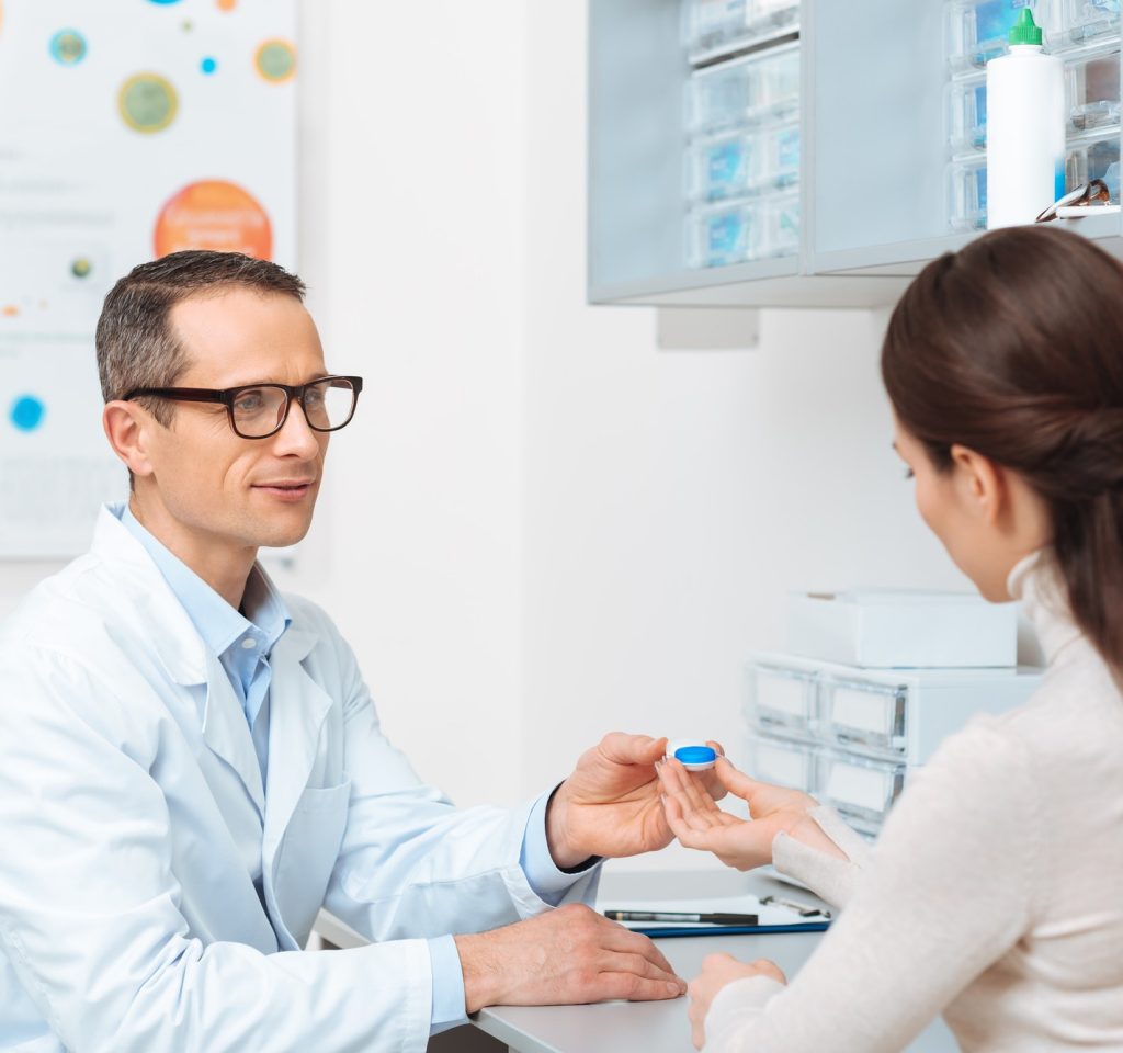 side-view-of-ophthalmologist-in-eyeglasses-giving-contact-lens-to-patient-in-clinic.jpg