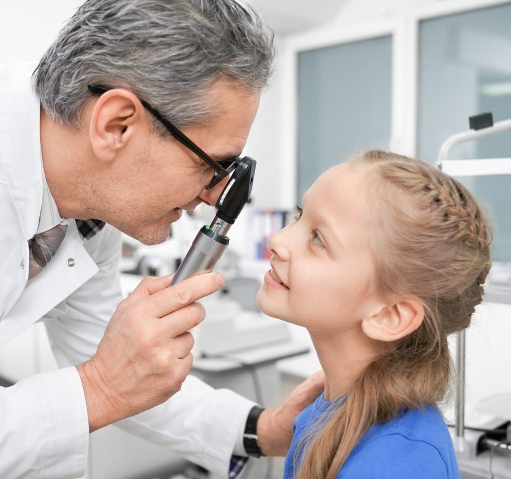 view-from-side-of-oculist-checking-sight-of-girl-in-clinic.jpg